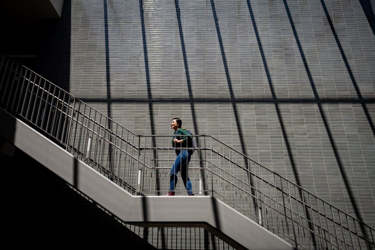 Commercial Photography of a student taking the stairs at CA Community Colleges