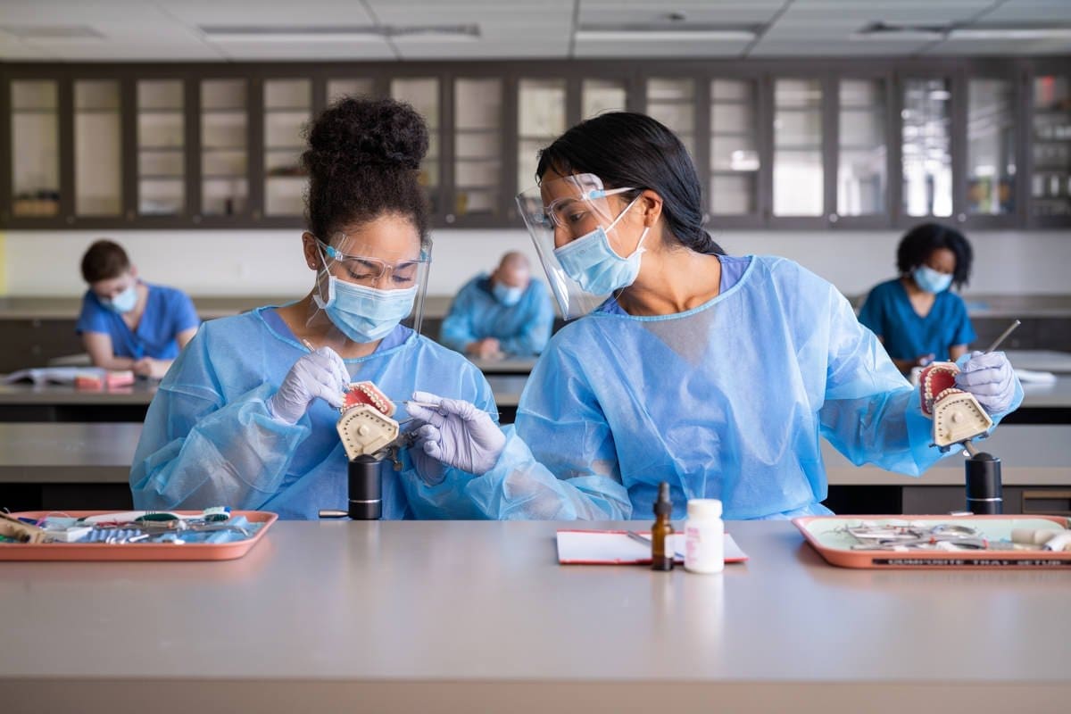 Dental Students help one another in this commercial photograph for CA Community Colleges