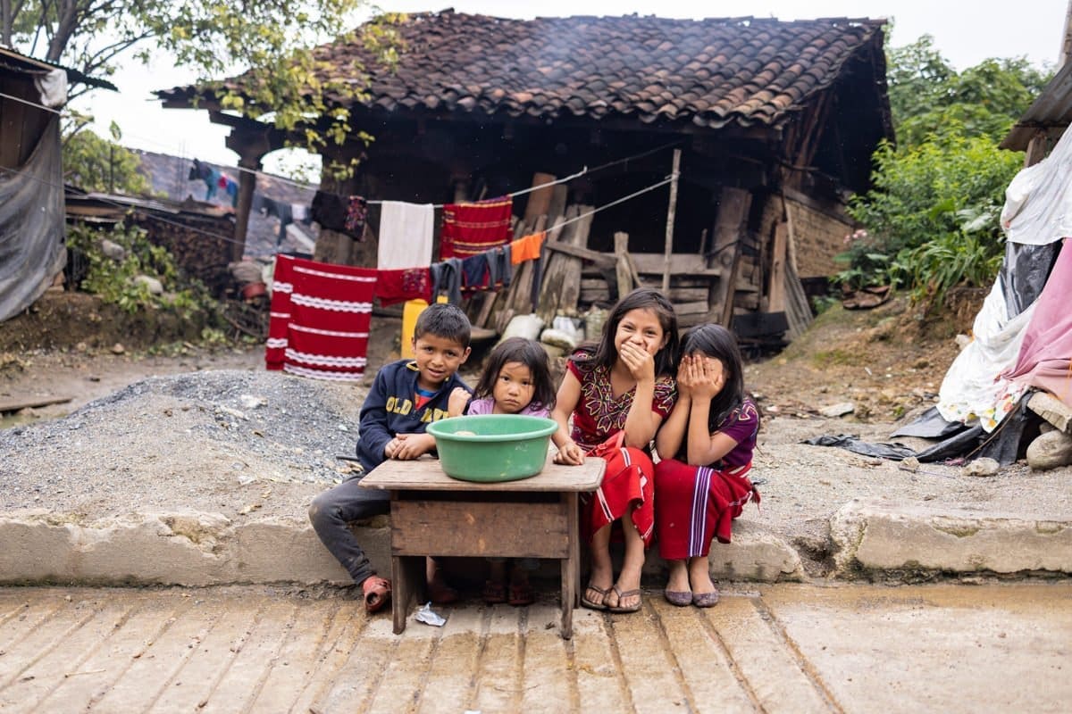 Children having a moment of fun while selling food on the streets of Chajul.