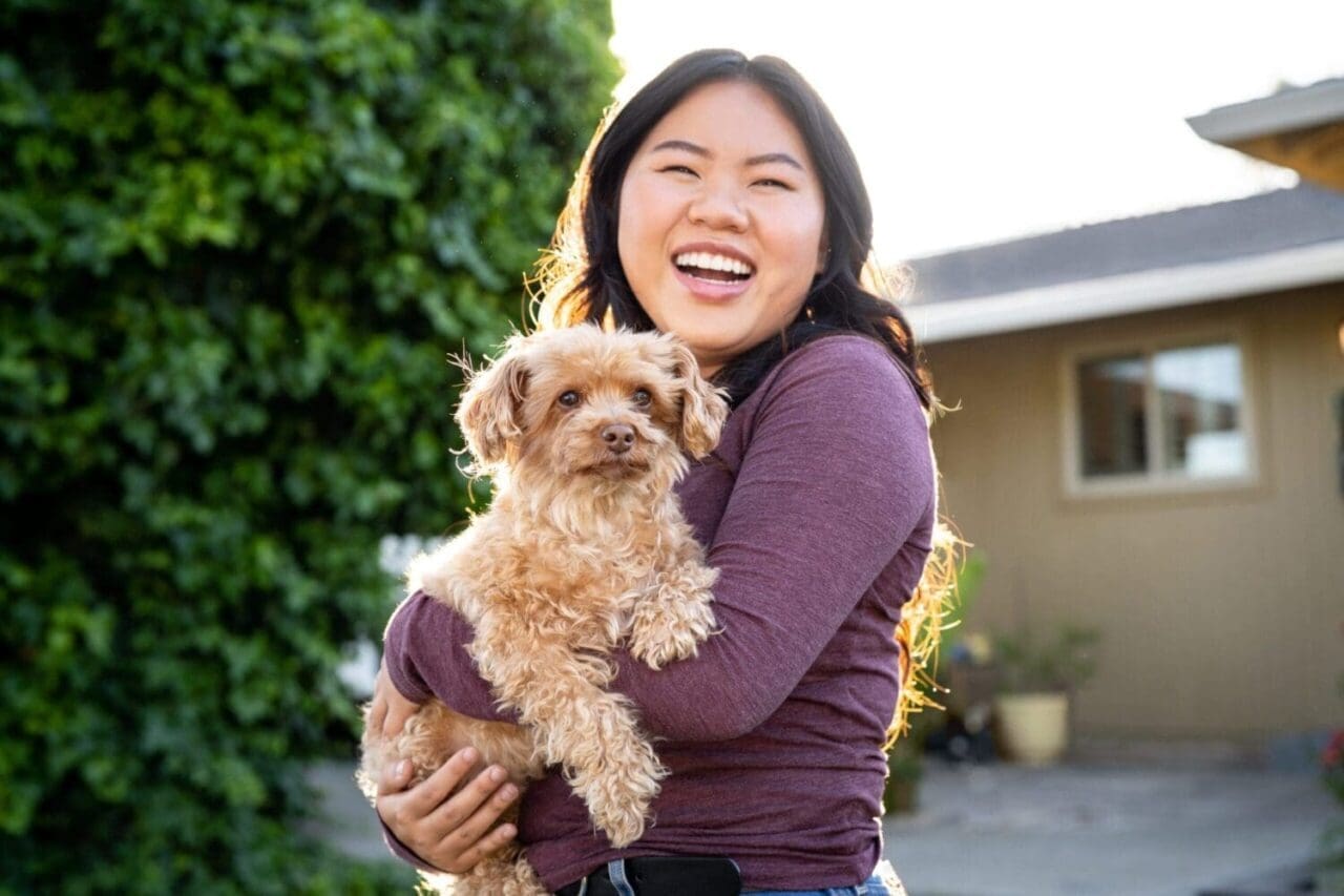 Commercial photograph of a woman holding her dog